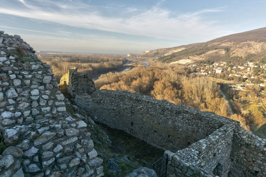 View of the ancient stone walls of Devin Castle overlooking the river valley and forested hills under a clear sky in Bratislava IV Bratislava Region Slovakia. View of the ancient stone walls of Devin Castle overlooking the river valley and forested hills under a clear sky in Bratislava IV Bratislava Region Slovakia.