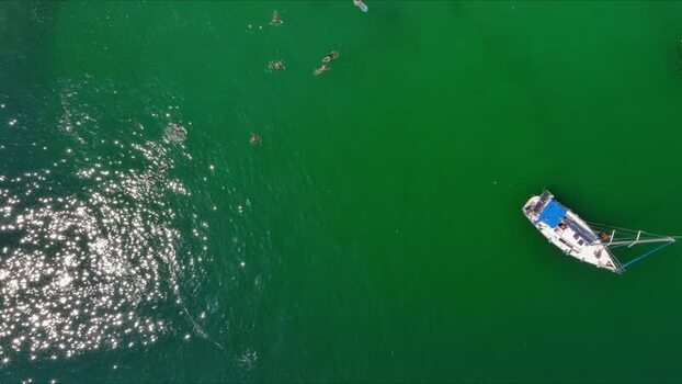 Aerial view of a boat in the green waters of Thasos Greece. Aerial view of a boat in the green waters of Thasos Greece.