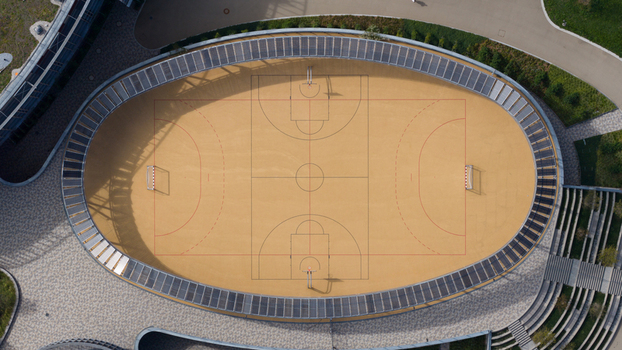Durmersheim Germany 12 September 2026 Aerial view of the oval sports court at Wilhelm Hausenstein Gymnasium with surrounding paved walkways and tiered seating.