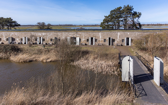Aerial view of the weathered stone fortress walls reflected in the tranquil waters below revealing a landscape rich with history Naarden Netherlands. Aerial view of the weathered stone fortress walls reflected in the tranquil waters below revealing a landscape rich with history Naarden Netherlands.