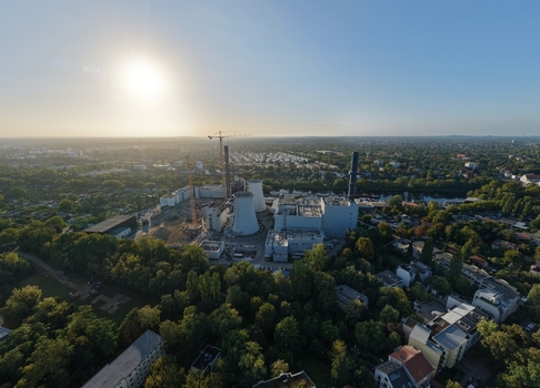 Aerial view of the deconstruction of the Heizkraftwerk Lichterfelde power plant with cooling towers and construction cranes surrounded by urban greenery in Berlin Berlin Germany. Aerial view of the deconstruction of the Heizkraftwerk Lichterfelde power plant with cooling towers and construction cranes surrounded by urban greenery in Berlin Berlin Germany.