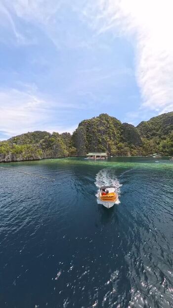 FPV aerial view of a boat in Coron bay Philippines.
