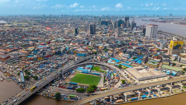 Aerial view of Lagos Island featuring dense urban architecture a football pitch highway overpasses and the waterfront in Lagos Lagos Nigeria.