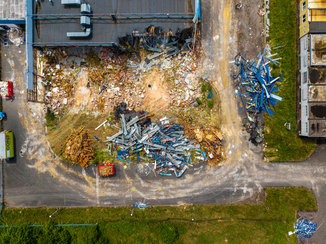 Aerial view of a demolition site with piles of metal debris scattered construction materials and a partially collapsed building structure Zebrak Central Bohemian Region Czechia. Aerial view of a demolition site with piles of metal debris scattered construction materials and a partially collapsed building structure Zebrak Central Bohemian Region Czechia.