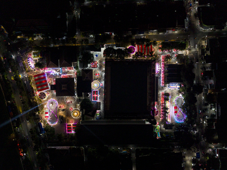 Aerial view of GOR Gelarsena Klaten Night Market with brightly lit amusement rides and colorful stalls at night Kecamatan Klaten Utara Jawa Tengah Indonesia. Aerial view of GOR Gelarsena Klaten Night Market with brightly lit amusement rides and colorful stalls at night Kecamatan Klaten Utara Jawa Tengah Indonesia.