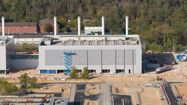 Aerial view of Data4 Hanau data center construction site with industrial buildings cranes and heavy machinery surrounded by forest in Hanau Hessen Germany. Aerial view of Data4 Hanau data center construction site with industrial buildings cranes and heavy machinery surrounded by forest in Hanau Hessen Germany.