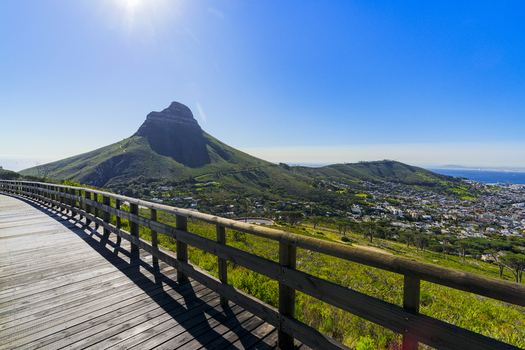 View of Lion s Head mountain peak from a wooden boardwalk under a clear blue sky in Cape Town Western Cape South Africa. View of Lion s Head mountain peak from a wooden boardwalk under a clear blue sky in Cape Town Western Cape South Africa.