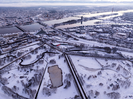 Aerial view of the snow covered city of Riga featuring the Daugava River bridges the National Library of Latvia and urban parks under a winter sky. Riga Latvia.