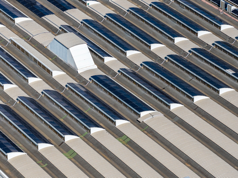 Aerial view of an industrial facility roof featuring rows of solar panels and skylights in Spoleto Umbria Italy. Aerial view of an industrial facility roof featuring rows of solar panels and skylights in Spoleto Umbria Italy.