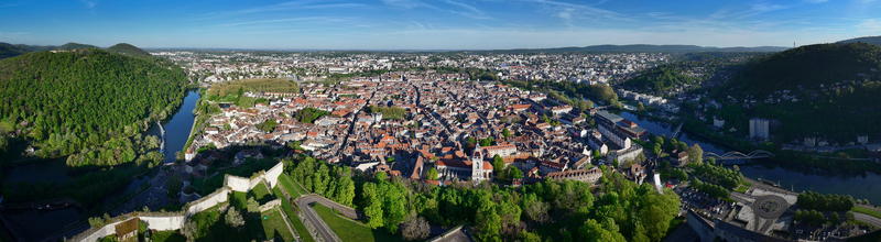 Aerial view of the Besancon Citadel overlooking the historic city center nestled within the Doubs river loop and surrounded by green hills in Besancon Bourgogne Franche Comte France. Aerial view of the Besancon Citadel overlooking the historic city center nestled within the Doubs river loop and surrounded by green hills in Besancon Bourgogne Franche Comte France.