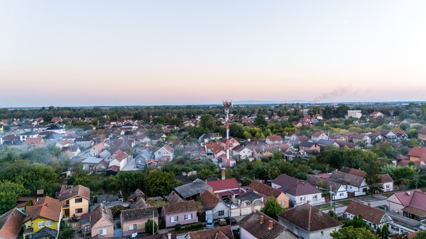 Aerial view of the town of Sremska Mitrovica with residential houses a tall telecommunications tower and surrounding greenery in Sremska Mitrovica Vojvodina Serbia.