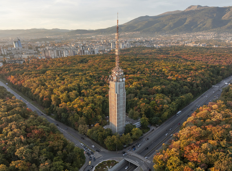 Aerial view of Sofia TV Tower surrounded by vibrant autumn forest with city skyline and Vitosha mountain in the background Sofia Sofia City Province Bulgaria. Aerial view of Sofia TV Tower surrounded by vibrant autumn forest with city skyline and Vitosha mountain in the background Sofia Sofia City Province Bulgaria.
