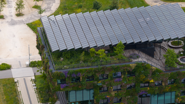 Aerial view of a modern sustainable building with solar panels and lush green vegetated roofs in Almere Flevoland Netherlands. Aerial view of a modern sustainable building with solar panels and lush green vegetated roofs in Almere Flevoland Netherlands.