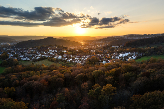Aerial view of the historic town surrounded by colorful autumn forests and rolling hills under a golden sunset sky Tubingen Baden Wurttemberg Germany. Aerial view of the historic town surrounded by colorful autumn forests and rolling hills under a golden sunset sky Tubingen Baden Wurttemberg Germany.