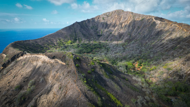 Aerial view of the Koko Head volcano its slopes a tapestry of scorched earth meeting lush greenery within the crater Honolulu Hawaii United States. Aerial view of the Koko Head volcano its slopes a tapestry of scorched earth meeting lush greenery within the crater Honolulu Hawaii United States.