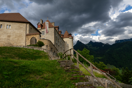 Gruyeres Switzerland 14 May 2026 View of the historic Chateau de Gruyeres with its stone walls and towers under a dramatic cloudy sky with mountains in the background. Gruyeres Switzerland 14 May 2026 View of the historic Chateau de Gruyeres with its stone walls and towers under a dramatic cloudy sky with mountains in the background.
