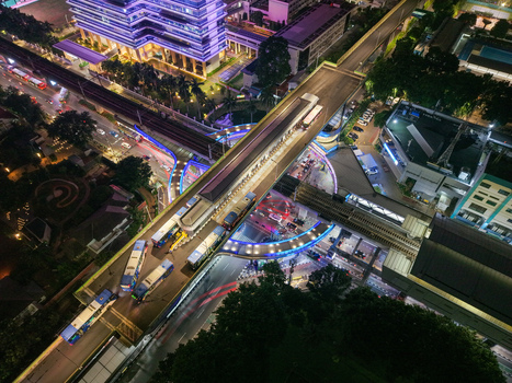 Aerial view of CSW Kebayoran Baru illuminated at night with buses on the elevated transit interchange and traffic light trails in Kecamatan Kebayoran Baru Daerah Khusus Ibukota Indonesia.