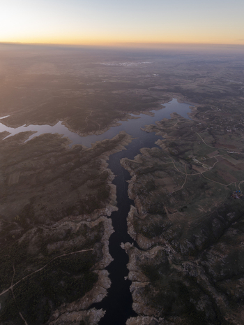 Aerial view of the winding reservoir surrounded by rugged hills and rural landscape at sunset in Kirklareli Merkez Kirklareli Turkey. Aerial view of the winding reservoir surrounded by rugged hills and rural landscape at sunset in Kirklareli Merkez Kirklareli Turkey.