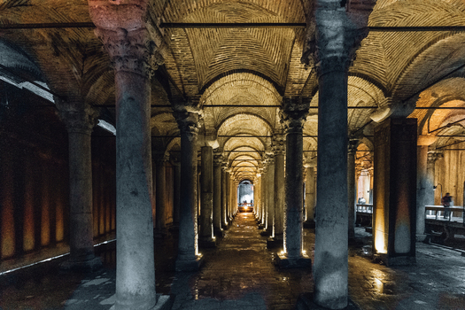 Istanbul Turkiye 07 October 2019 View of the Basilica Cistern s majestic columns rising from the water illuminated by warm light creating a cavernous awe inspiring space.