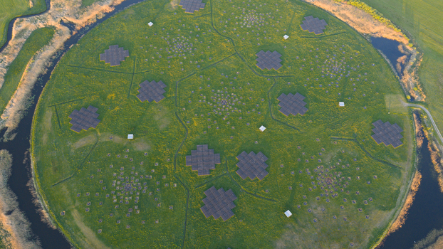 Aerial view of the LOFAR superterp radio telescope antenna arrays on a circular green island surrounded by a moat in Buinen Drenthe Netherlands. Aerial view of the LOFAR superterp radio telescope antenna arrays on a circular green island surrounded by a moat in Buinen Drenthe Netherlands.
