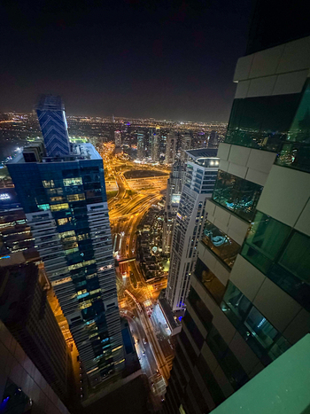 View of Dubai Marina at night with illuminated skyscrapers busy traffic on the highway and glowing city lights in Dubai Dubai United Arab Emirates. View of Dubai Marina at night with illuminated skyscrapers busy traffic on the highway and glowing city lights in Dubai Dubai United Arab Emirates.