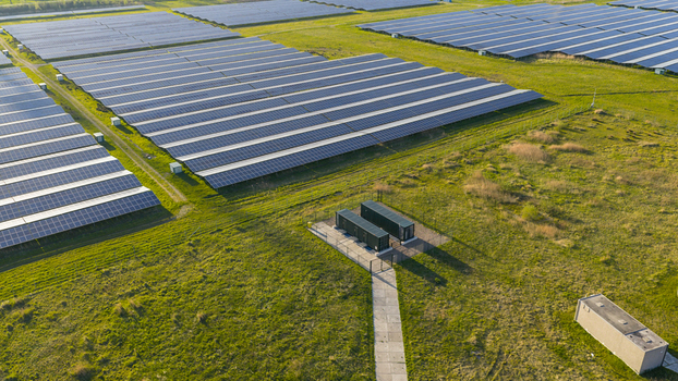 Aerial view of rows of solar panels in a large photovoltaic power plant surrounded by green fields Farmsum Groningen Netherlands.