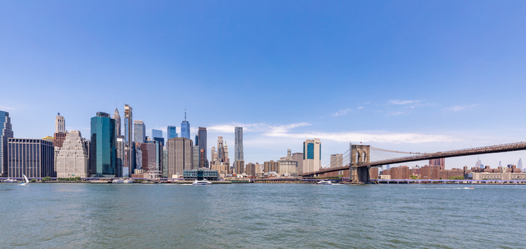 View of the iconic New York City skyline featuring the Brooklyn Bridge spanning the East River under a clear blue sky New York New York United States. View of the iconic New York City skyline featuring the Brooklyn Bridge spanning the East River under a clear blue sky New York New York United States.
