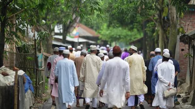 View of Muslim men walking on a village path in Bangladesh. View of Muslim men walking on a village path in Bangladesh.