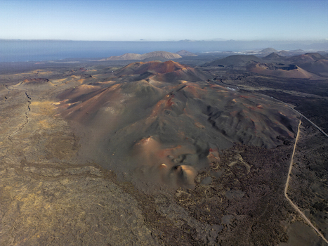 Aerial view of the volcanic craters and rugged lava fields of Timanfaya National Park in Lanzarote Canarias Spain. Aerial view of the volcanic craters and rugged lava fields of Timanfaya National Park in Lanzarote Canarias Spain.