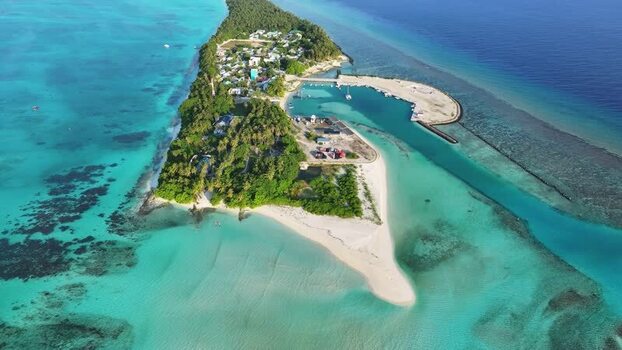 Aerial view of Fulhadhoo island with turquoise waters Maldives.