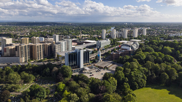 Aerial view of modern apartment buildings commercial offices and lush green parkland in the urban landscape of Brentford England United Kingdom. Aerial view of modern apartment buildings commercial offices and lush green parkland in the urban landscape of Brentford England United Kingdom.
