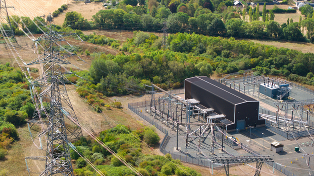 Aerial view of Eaton Socon Substation with high voltage power lines electrical infrastructure and surrounding green landscape St. Neots England United Kingdom. Aerial view of Eaton Socon Substation with high voltage power lines electrical infrastructure and surrounding green landscape St. Neots England United Kingdom.