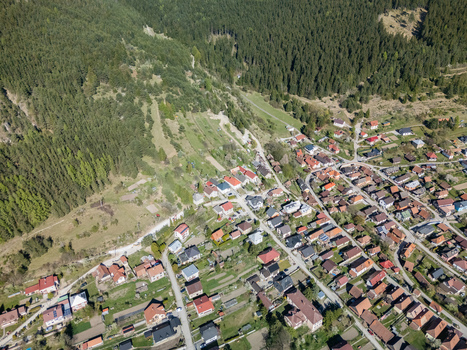Aerial view of the village of Valaska Dubova nestled at the foot of a dense green forest on a sunny day in Valaska Dubova Zilina Region Slovakia. Aerial view of the village of Valaska Dubova nestled at the foot of a dense green forest on a sunny day in Valaska Dubova Zilina Region Slovakia.