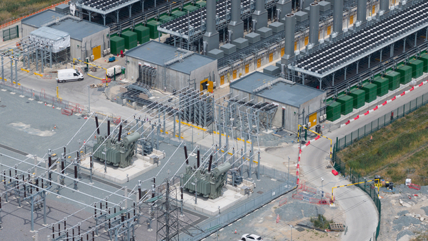 Aerial view of Thurrock Flexible Generation Substation featuring large transformers electrical infrastructure cooling units and service roads in Tilbury England United Kingdom.
