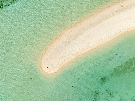 Aerial view of Malcapuya Island featuring a pristine white sandbar surrounded by clear turquoise water in Coron Mimaropa Philippines. Aerial view of Malcapuya Island featuring a pristine white sandbar surrounded by clear turquoise water in Coron Mimaropa Philippines.