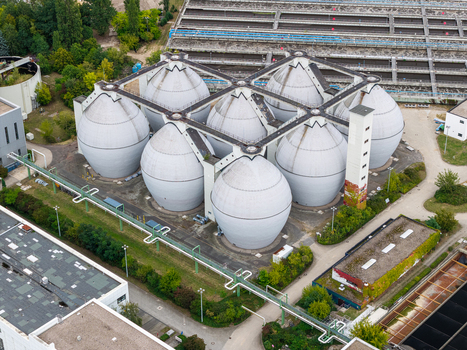 Aerial view of the egg shaped digester tanks at the Klarwerk Ruhleben sewage treatment plant surrounded by industrial infrastructure and greenery in Berlin Berlin Germany.