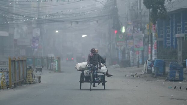 View of a person riding a bicycle through heavy fog Bangladesh. View of a person riding a bicycle through heavy fog Bangladesh.