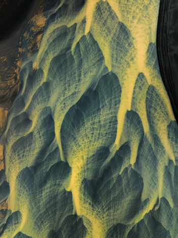 Aerial view of braided glacial rivers carve through the stark landscape creating a mesmerizing tapestry of gold against the dark earth Iceland. Aerial view of braided glacial rivers carve through the stark landscape creating a mesmerizing tapestry of gold against the dark earth Iceland.