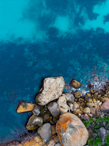 Aerial view of Bettys Beach featuring large granite boulders resting along the turquoise coastline in Albany WA Australia. Aerial view of Bettys Beach featuring large granite boulders resting along the turquoise coastline in Albany WA Australia.