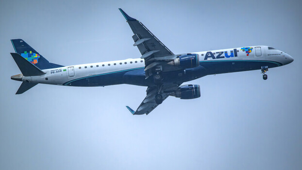 Rio de Janeiro Brazil 20 May 2026 View of an Azul Brazilian Airlines Embraer E195 E2 aircraft with landing gear extended flying against an overcast sky.