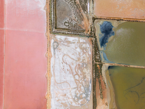 Aerial view of the colorful salt evaporation ponds at Salines des Trenc with vibrant pink and white geometric patterns in Campos Islas Baleares Spain. Aerial view of the colorful salt evaporation ponds at Salines des Trenc with vibrant pink and white geometric patterns in Campos Islas Baleares Spain.
