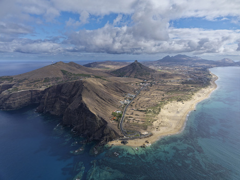 Aerial view of Ponta da Calheta featuring rugged cliffs sandy beaches turquoise waters and the coastal landscape of Porto Santo Madeira Portugal. Aerial view of Ponta da Calheta featuring rugged cliffs sandy beaches turquoise waters and the coastal landscape of Porto Santo Madeira Portugal.