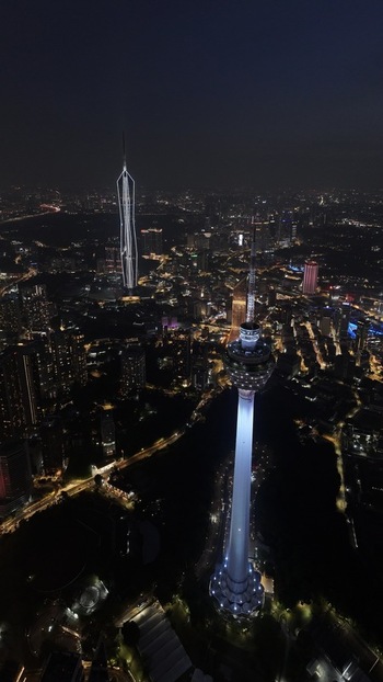 Aerial view of the illuminated KL Tower and Merdeka 118 skyscraper amidst the glowing city lights at night in Kuala Lumpur Federal Territory of Malaysia. Aerial view of the illuminated KL Tower and Merdeka 118 skyscraper amidst the glowing city lights at night in Kuala Lumpur Federal Territory of Malaysia.