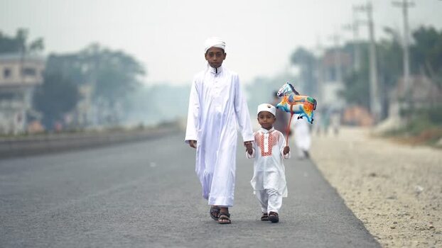 View of two boys in traditional attire walking on a road Bangladesh. View of two boys in traditional attire walking on a road Bangladesh.
