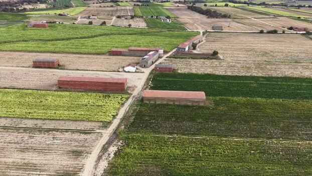 Aerial view of agricultural fields and farm buildings in Spain. Aerial view of agricultural fields and farm buildings in Spain.