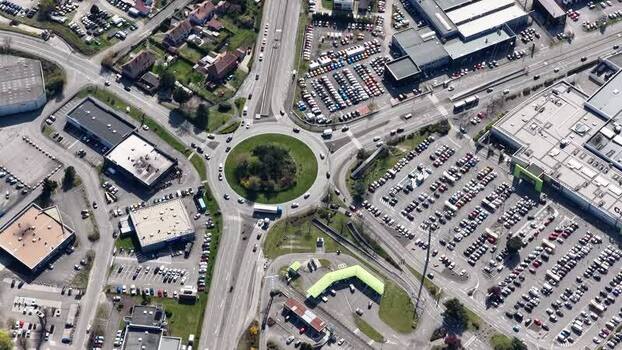 Aerial view of roundabout and retail buildings France.