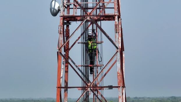 Aerial view of a technician climbing a telecom tower Bangladesh.