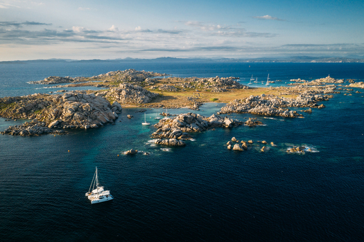 Aerial view of group of sail boats anchored at Lavezzu Island Corsica France.