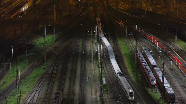 Aerial view of Hauptbahnhof railway tracks at night Germany.