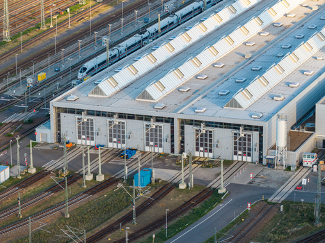Aerial view of the ICE Werk Berlin Rummelsburg maintenance facility with high speed trains on tracks and large industrial halls in Berlin Berlin Germany. Aerial view of the ICE Werk Berlin Rummelsburg maintenance facility with high speed trains on tracks and large industrial halls in Berlin Berlin Germany.